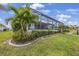 Screened in patio with a view of the water, landscaping, and a lush green lawn at 19246 Moore Haven Ct, Port Charlotte, FL 33948