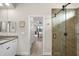 Bathroom leading to the bedroom with granite counters, a modern glass shower, and wood-look tile at 19246 Moore Haven Ct, Port Charlotte, FL 33948
