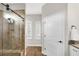 Well-lit bathroom features a glass-enclosed shower and white cabinets at 19246 Moore Haven Ct, Port Charlotte, FL 33948