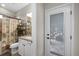 Bathroom with granite vanity, tub-shower combo and access to the pool area at 19246 Moore Haven Ct, Port Charlotte, FL 33948