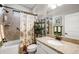 Bathroom featuring a shower-tub combo, granite countertops, and stylish towel racks at 19246 Moore Haven Ct, Port Charlotte, FL 33948
