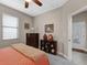 Comfortable bedroom with carpet floors and a ceiling fan, offering ample space and natural light at 19246 Moore Haven Ct, Port Charlotte, FL 33948