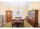Elegant dining room with chandelier, plantation shutters and classic furniture set at 19246 Moore Haven Ct, Port Charlotte, FL 33948