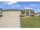 Charming single-Gathering home with a three car garage, lush lawn, and well manicured landscaping at 19246 Moore Haven Ct, Port Charlotte, FL 33948