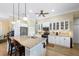 Well-lit kitchen with granite countertops, stainless steel appliances, and a central island with seating at 19246 Moore Haven Ct, Port Charlotte, FL 33948