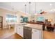 Open kitchen featuring granite countertops, stainless steel dishwasher, and flows into the adjacent living area at 19246 Moore Haven Ct, Port Charlotte, FL 33948