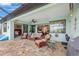 Inviting covered lanai with comfortable seating, tile flooring, and seamless access to the indoor living spaces at 19246 Moore Haven Ct, Port Charlotte, FL 33948