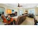 Spacious living room featuring a fireplace, modern ceiling fan, and a comfortable leather sofa set at 19246 Moore Haven Ct, Port Charlotte, FL 33948