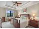 Bright main bedroom with trey ceiling, large window and well-appointed furniture at 19246 Moore Haven Ct, Port Charlotte, FL 33948