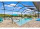 Sparkling pool surrounded by a screened enclosure, providing a private and refreshing outdoor space at 19246 Moore Haven Ct, Port Charlotte, FL 33948