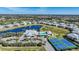 Aerial view of the community clubhouse, pool, tennis courts, and surrounding homes at 2160 Heron Lake Dr # 201, Punta Gorda, FL 33983