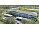 Aerial view of condo buildings, a pond, and covered parking at 2160 Heron Lake Dr # 201, Punta Gorda, FL 33983