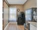 Charming wet bar features custom cabinet, drink refrigerator, and beverage center in a naturally lit space at 2160 Heron Lake Dr # 201, Punta Gorda, FL 33983