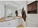 Bathroom features a double sink vanity, large mirror with Hollywood lighting, and mocha-colored accents at 2160 Heron Lake Dr # 201, Punta Gorda, FL 33983