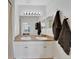 Bathroom features a double sink vanity, large mirror with Hollywood lighting, and mocha-colored accents at 2160 Heron Lake Dr # 201, Punta Gorda, FL 33983