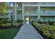 Well-maintained building entrance with landscaped walkway providing a welcoming atmosphere for residents and guests at 2160 Heron Lake Dr # 201, Punta Gorda, FL 33983