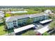 Attractive three-story condo building with covered parking and tropical landscaping in a waterfront community at 2160 Heron Lake Dr # 201, Punta Gorda, FL 33983
