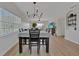 Bright dining area with table for four, leading to the living room, and views to outdoor balcony at 2160 Heron Lake Dr # 201, Punta Gorda, FL 33983