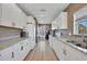 Modern kitchen featuring white cabinets, granite countertops, and stainless steel appliances at 2160 Heron Lake Dr # 201, Punta Gorda, FL 33983