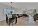 Open concept living and dining area offering stylish chandelier, comfortable seating, and outdoor balcony at 2160 Heron Lake Dr # 201, Punta Gorda, FL 33983