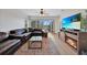 Comfortable living room features modern decor, fireplace, balcony access, and view of a beautiful green space at 2160 Heron Lake Dr # 201, Punta Gorda, FL 33983