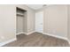 A bedroom featuring an open closet, a door, and vinyl wood flooring at 219 Martin Ne Dr, Port Charlotte, FL 33952