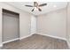 Bedroom featuring a ceiling fan, an open closet, and vinyl wood flooring at 219 Martin Ne Dr, Port Charlotte, FL 33952