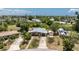 Aerial view of a single-Gathering home featuring lush landscaping and a private driveway in a tranquil neighborhood setting at 219 Martin Ne Dr, Port Charlotte, FL 33952