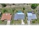 Aerial view of home showcasing the screened pool, backyard, mature landscaping, and neighboring properties at 2193 Beacon Dr, Port Charlotte, FL 33952