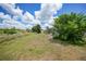 The expansive backyard has partial shade and leads up to the screened in pool at 2193 Beacon Dr, Port Charlotte, FL 33952