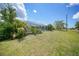 View of the lawn leading to the screened pool, with palm trees at 2193 Beacon Dr, Port Charlotte, FL 33952