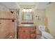 Bathroom features tiled walk-in shower with granite vanity, modern lighting, and neutral paint at 2193 Beacon Dr, Port Charlotte, FL 33952