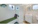Bathroom features a shower, mirror, storage, and bench with a bright vanity at 2193 Beacon Dr, Port Charlotte, FL 33952