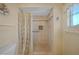 Shower with neutral tiles, safety bar and curtain at 2193 Beacon Dr, Port Charlotte, FL 33952