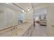 Bathroom vanity with tile floors, marble countertop, and open view to the primary bedroom at 2193 Beacon Dr, Port Charlotte, FL 33952