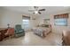 Bedroom features tiled flooring, a ceiling fan, a large bed and plentiful natural light from the windows at 2193 Beacon Dr, Port Charlotte, FL 33952