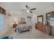 Bedroom features tiled flooring, a ceiling fan, plentiful natural light and matching wood furniture at 2193 Beacon Dr, Port Charlotte, FL 33952