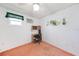 Small bedroom offers a ceiling fan, one window and an area for a desk at 2193 Beacon Dr, Port Charlotte, FL 33952