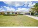 Well-maintained home featuring a neatly manicured lawn, brick accents, and a two-car garage at 2193 Beacon Dr, Port Charlotte, FL 33952