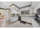 Bright kitchen featuring granite countertops, white cabinetry, and stainless steel appliances at 2193 Beacon Dr, Port Charlotte, FL 33952