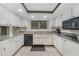 Well-maintained kitchen with granite counters, white cabinetry, and tile flooring at 2193 Beacon Dr, Port Charlotte, FL 33952