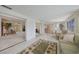 Spacious living room featuring tiled floors, large windows, and access to the bedroom at 2193 Beacon Dr, Port Charlotte, FL 33952