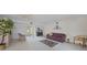 Bright and spacious living room with neutral carpeting, ceiling fan, and views of the front entrance at 2193 Beacon Dr, Port Charlotte, FL 33952