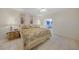 Comfortable bedroom with tiled floors, a ceiling fan, and access to the sunroom at 2193 Beacon Dr, Port Charlotte, FL 33952