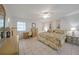 Well-lit primary bedroom with a ceiling fan, tiled floor, and a comfortable bed at 2193 Beacon Dr, Port Charlotte, FL 33952
