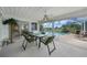 The screened-in patio features a dining table with views of the pool at 2193 Beacon Dr, Port Charlotte, FL 33952