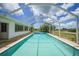The screened-in pool has clear blue water and provides a serene outdoor space at 2193 Beacon Dr, Port Charlotte, FL 33952