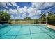 Relaxing screened-in pool area with serene views of the surrounding green space and blue skies at 2193 Beacon Dr, Port Charlotte, FL 33952