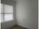 Bright bedroom featuring a window with blinds and wood-look flooring at 230 Waterway Cir Ne, Port Charlotte, FL 33952