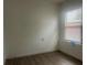 Bedroom with neutral paint and modern flooring illuminated by natural light from the window at 230 Waterway Cir Ne, Port Charlotte, FL 33952